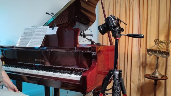 baby grand piano with camera and micrphones rigged